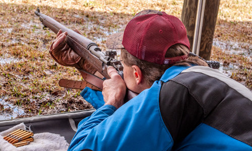 man shooting bolt rifle in Springfield Match