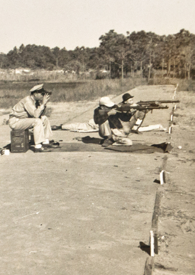 competitors shooting match on the beach