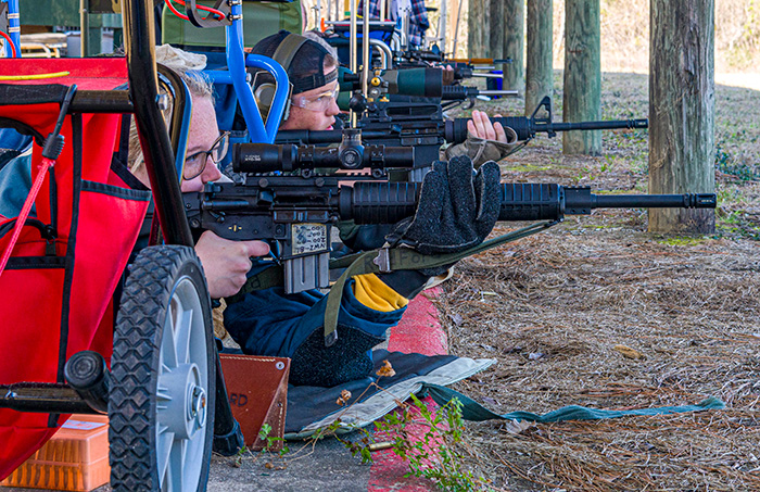 looking down the firing line at a low level looking at the competitors profile side as they shoot prone slow fire