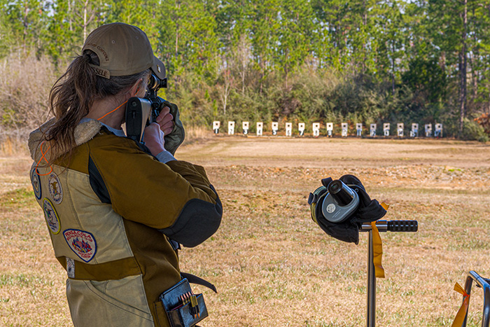 woman shooting the standing stage during a high power rifle match